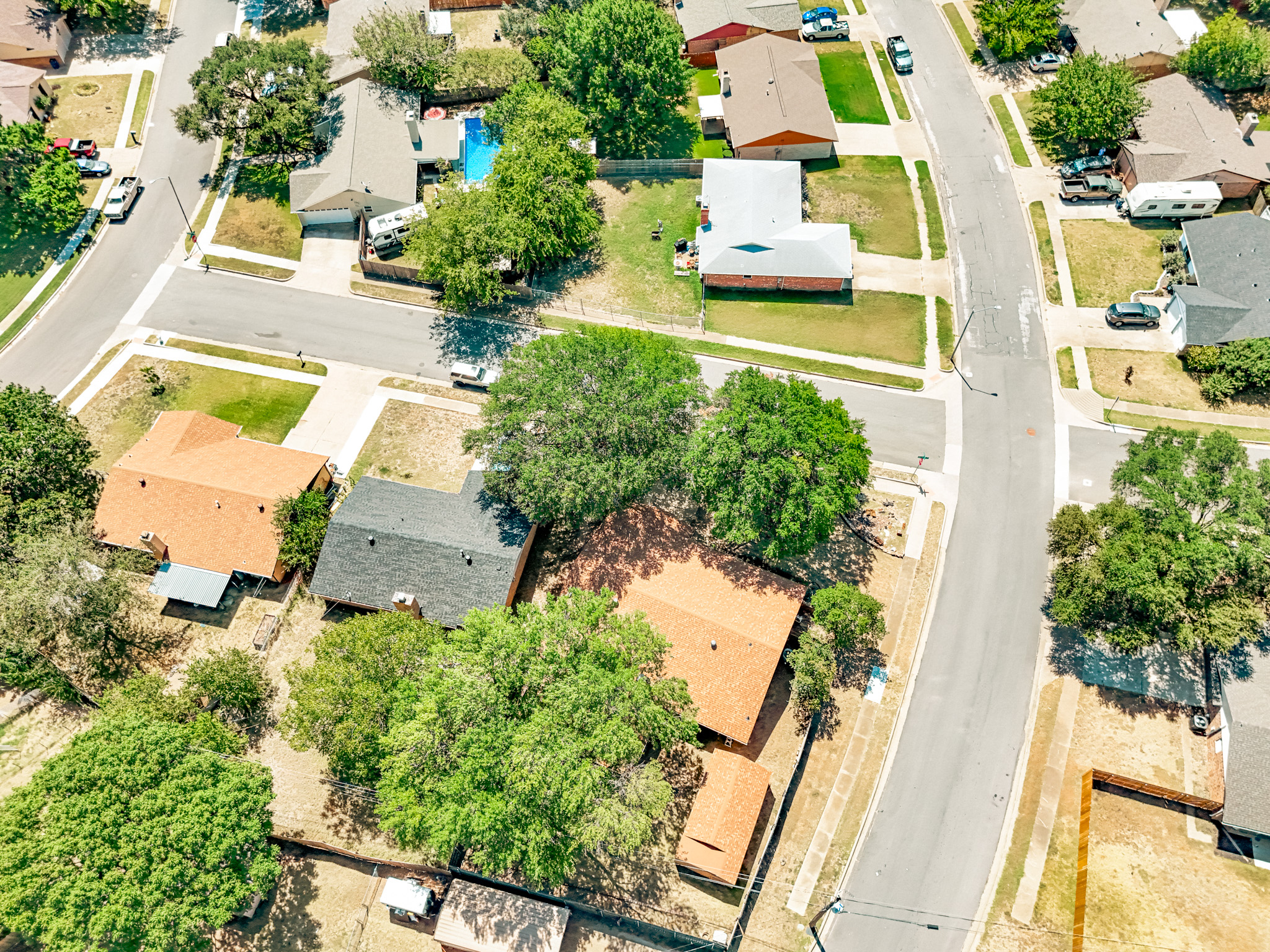 Curved neighborhood street reconstructed by Reliable Paving in Burleson, TX.