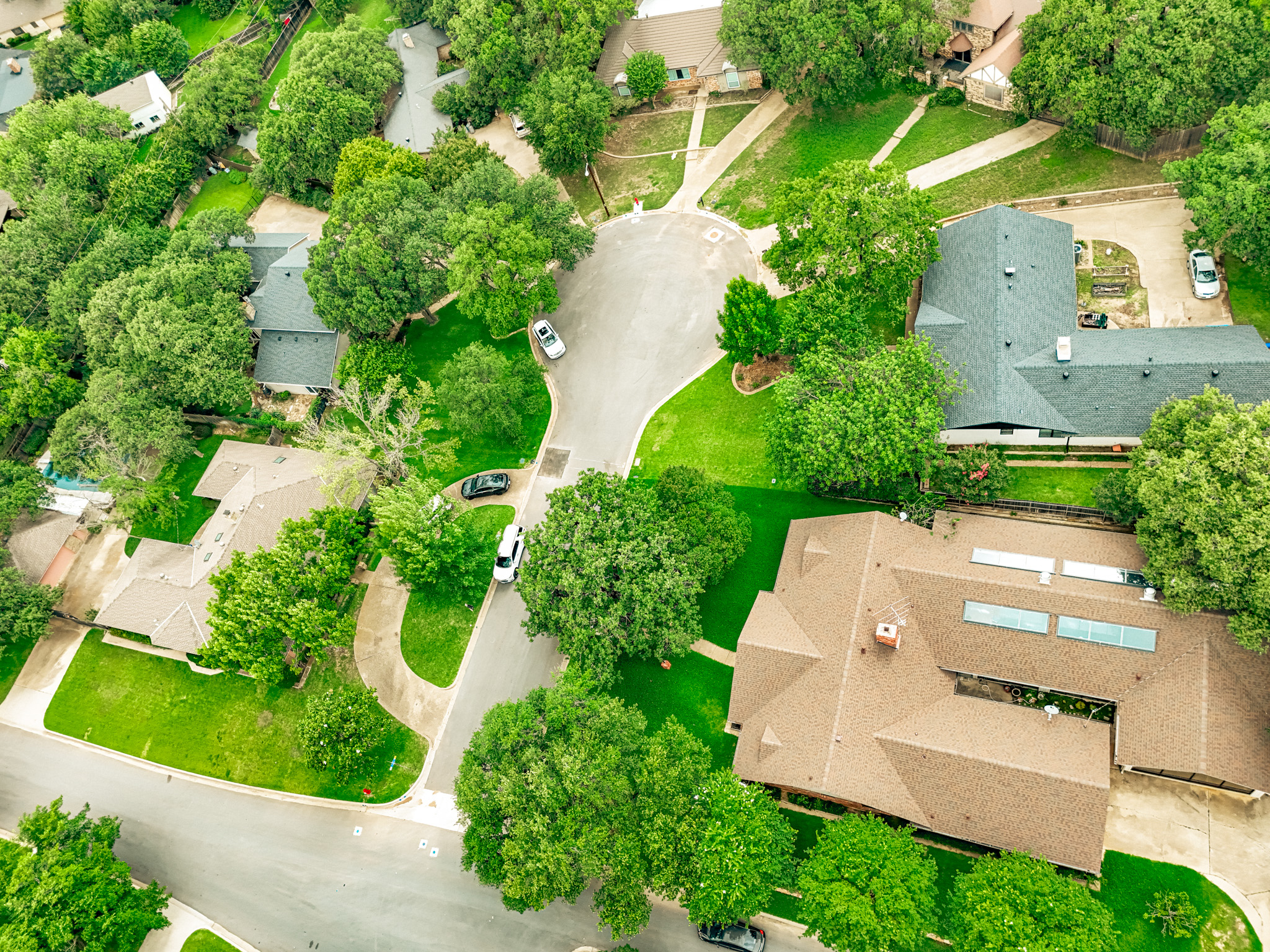 Freshly paved residential street in Colleyville, TX after rehabilitation by Reliable Paving, Inc.